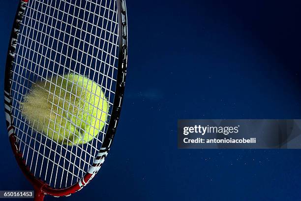 colored powdered tennis ball hitting tennis racket - impact stock pictures, royalty-free photos & images