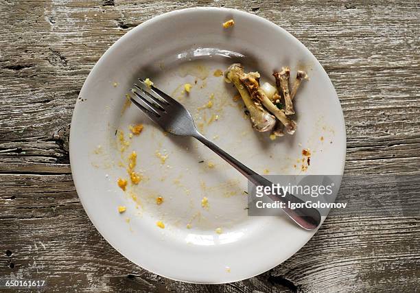 dirty plate with leftover chicken bones - leftover stock pictures, royalty-free photos & images