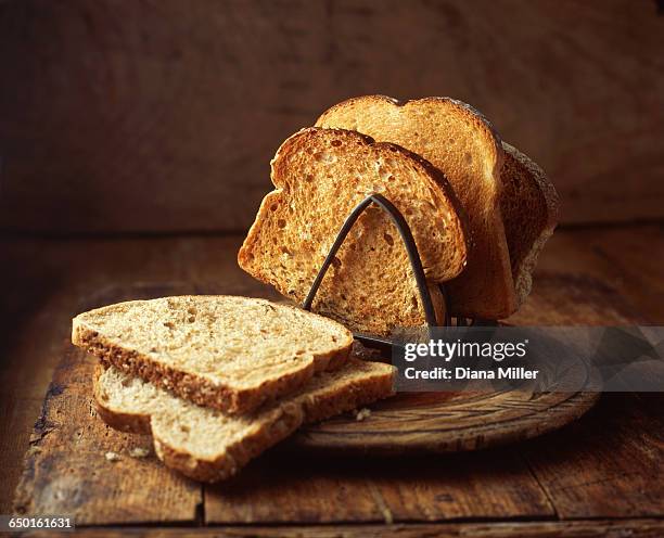 white and brown toast in toast rack, close-up - toast rack stock pictures, royalty-free photos & images