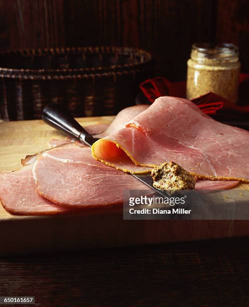 honey and mustard ham slices with whole grain mustard, on wooden chopping board - honey ham stock pictures, royalty-free photos & images