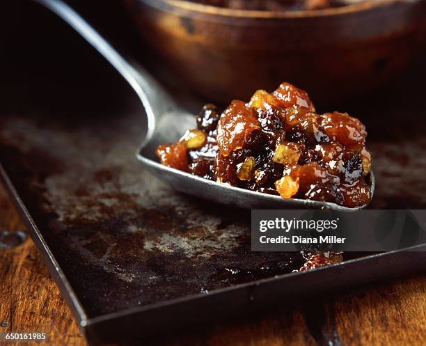 spoonful of dried fruit mince pie filling on metal tray - mince pie stock pictures, royalty-free photos & images