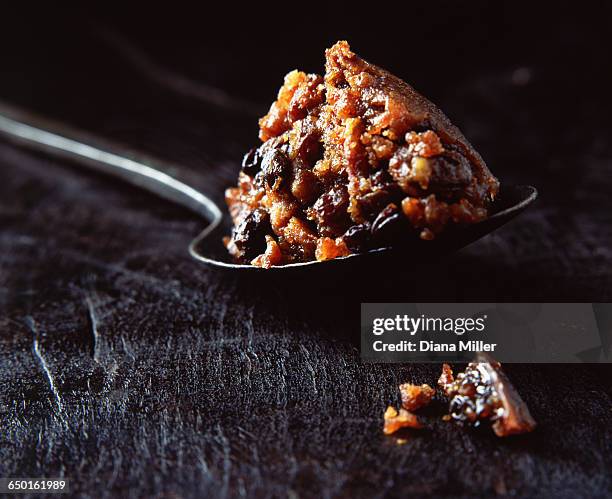 spoonful of christmas pudding on wooden surface - christmas pudding stock pictures, royalty-free photos & images