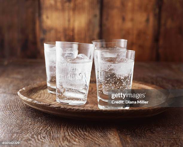 sparkling water in drinking glass with ice on vintage wooden plate - fizz bildbanksfoton och bilder