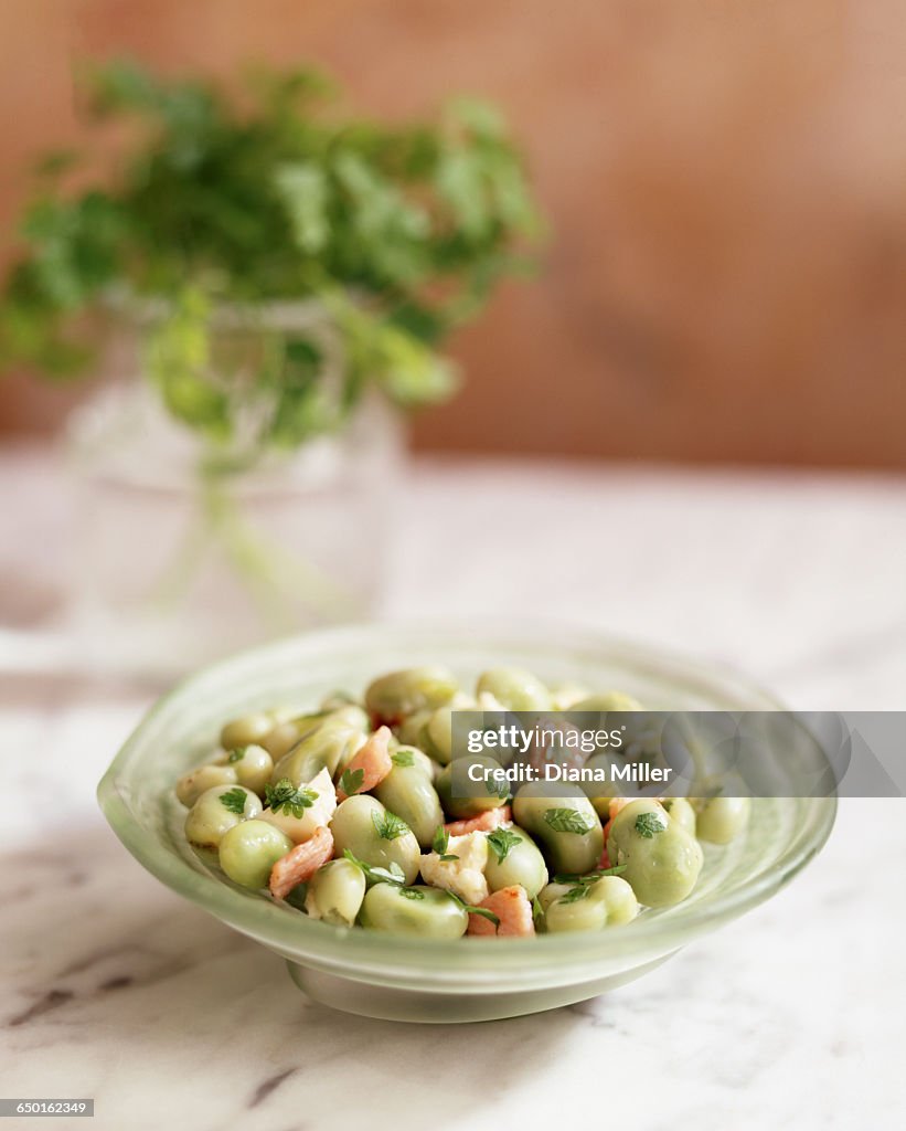 Butter beans with pancetta and parsley in bowl