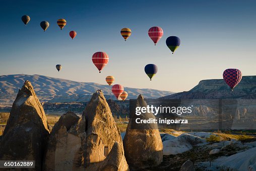 Hot air balloons at sunrise flying over Cappadocia, Goreme, Turkey