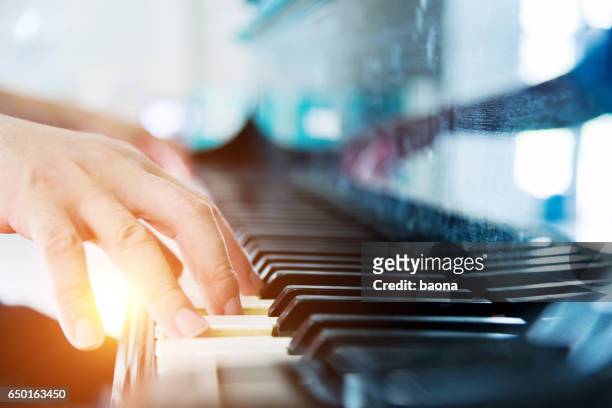 playing a piano - piano stock pictures, royalty-free photos & images