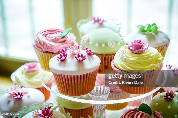 variety of pretty cupcakes on cakestand - cupcake photos et images de collection