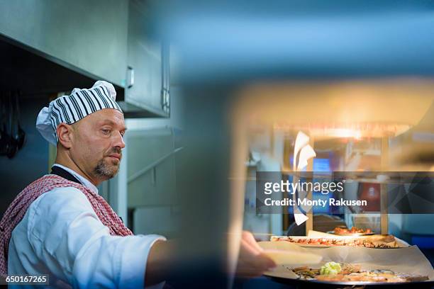 chef preparing food in traditional italian restaurant kitchen - otley stock pictures, royalty-free photos & images
