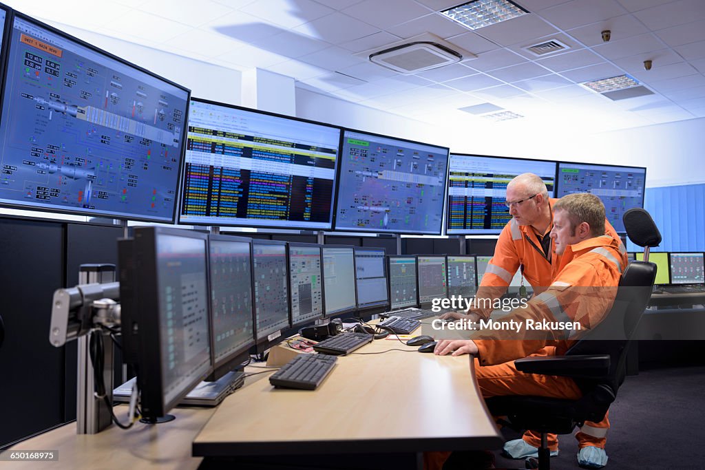 Workers in control room of gas-fired power station