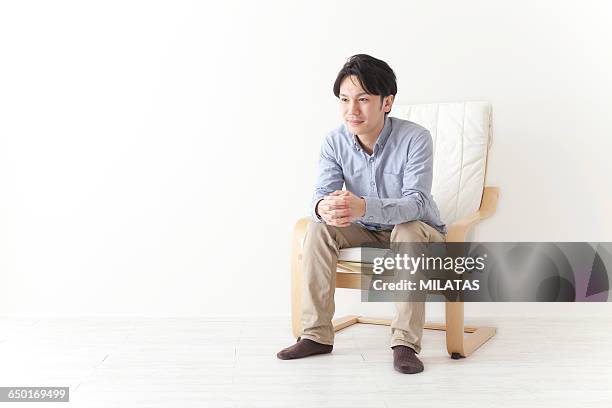 japanese man relax in the chair - khaki tan fotografías e imágenes de stock