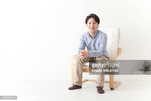 japanese man relax in the chair - khaki tan fotografías e imágenes de stock