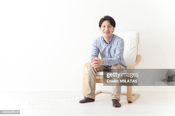 japanese man relax in the chair - khakibyxor bildbanksfoton och bilder