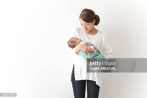 japanese woman huggy baby - baby on white stock-fotos und bilder