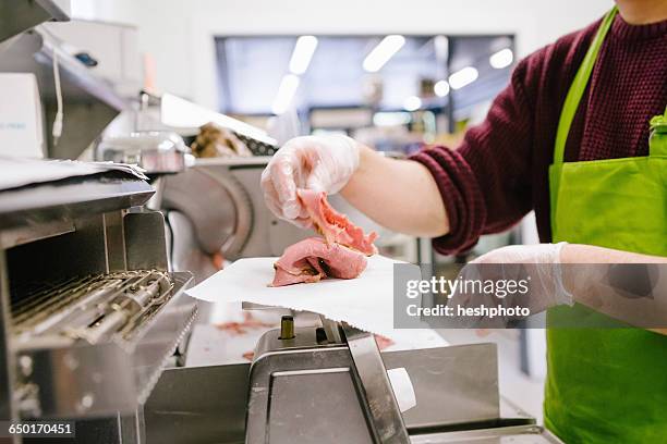 employee in general store weighing sliced meat in kitchen - デリカッセン ストックフォトと画像