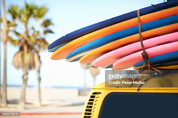 multi-coloured surfboards tied onto vehicle, venice beach, los angeles, usa - venice beach stock pictures, royalty-free photos & images
