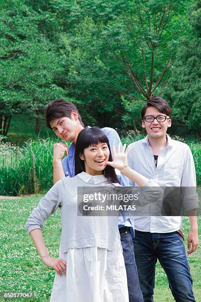 japanese students stand in grassland - people say hello stock pictures, royalty-free photos & images