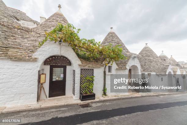 typical huts called trulli built with dry stone alberobello - trulli photos et images de collection