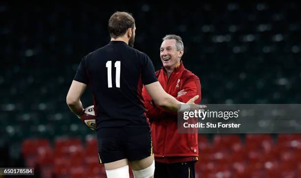 Wales captain Alun Wyn Jones shares a joke with head coach Robert Howley during Wales captain's run ahead of their RBS Six Nations match against...