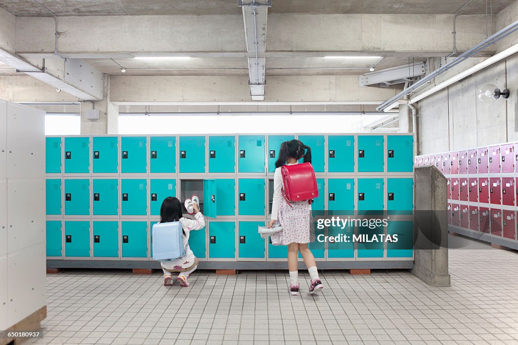 Japanese elementary school students changing wear the shoes in a locker