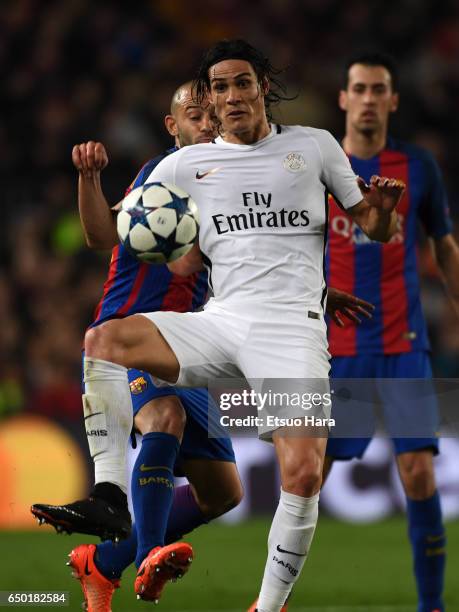 Edinson Cavani of Paris Saint-Germain controls the ball under pressure of Javier Mascherano of Barcelona during the UEFA Champions League Round of 16...