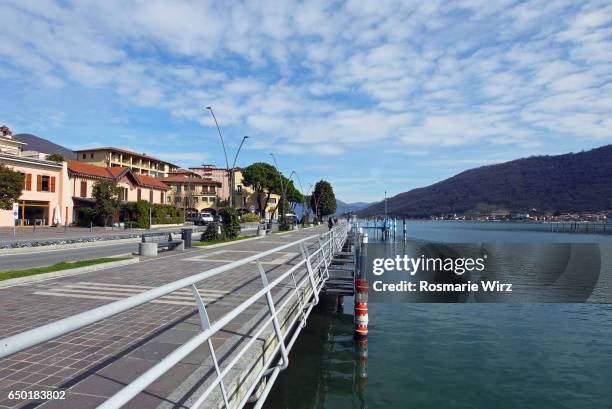 sarnico waterfront promenade with pine trees along lake iseo - sarnico stock pictures, royalty-free photos & images