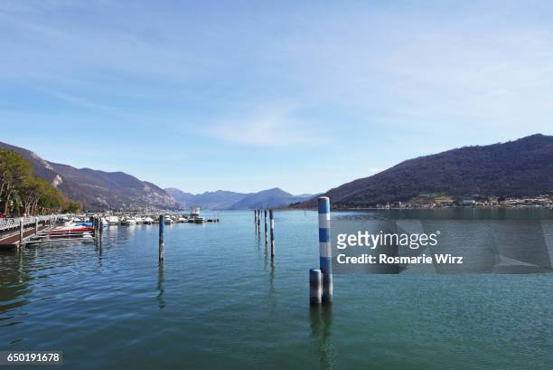 sarnico waterfront promenade with mountain view on lake iseo. - sarnico stock pictures, royalty-free photos & images