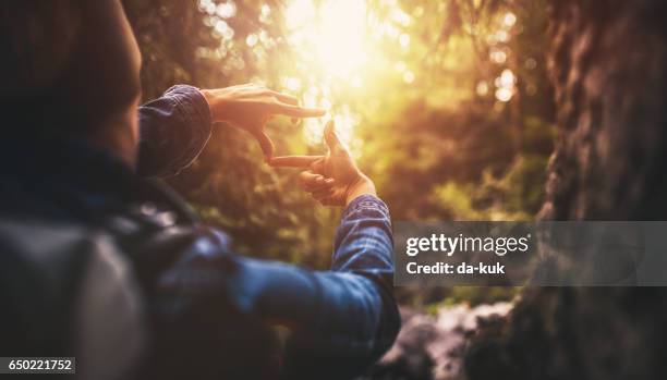 searching for best composition at sunset - finger frame stock pictures, royalty-free photos & images