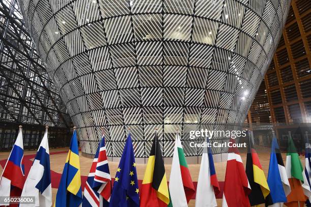 Flags in the arrival area of the Europa building at the Council of the European Union on the first day of an EU summit, on March 9, 2017 in Brussels,...