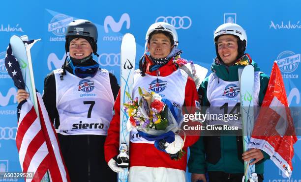 Ikuma Horishima of Japan celebrates winning the gold medal with silver medallist Bradley Wilson of the United States and bronze medallist Marco Tade...