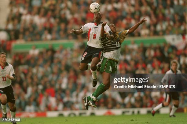 Ian Wright, England {L} gets to the high ball before Doctor Khumalo, South Africa {R}