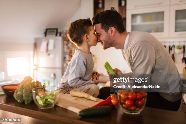 father and son having fun in the kitchen - kids cooking stock pictures, royalty-free photos & images