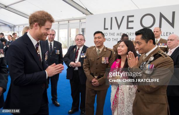 Britain's Prince Harry speaks with members of the Brigade of Gurkhas, at a reception on Horse Guards Parade in central London on March 9 after the...