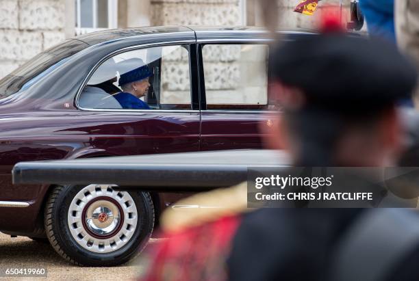 Queen Elizabeth II arrives by car to attend a service of dedication at Horse Guards Parade in central London on March 9 before the unveiling of The...