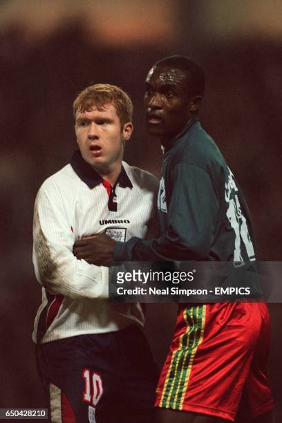 England's Paul Scholes and Cameroon's Ernest Etchi watch the action