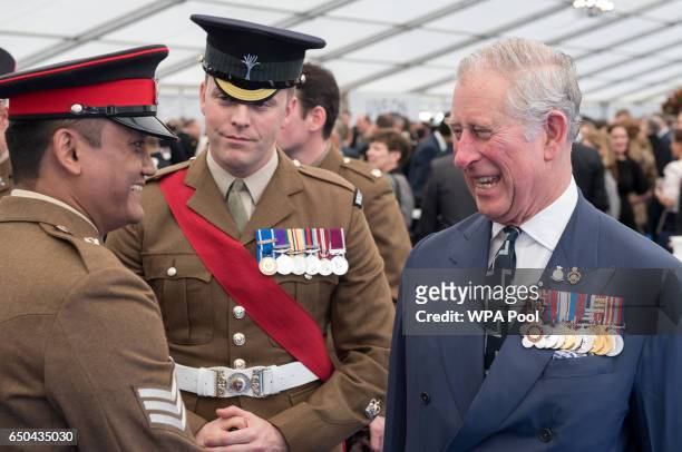 Prince Charles, Prince of Wales speaks with British military personnel at a reception following the unveiling of the new memorial to members of the...