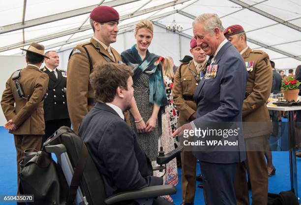 Prince Charles, Prince of Wales speaks with British military personnel at a reception following the unveiling of the new memorial to members of the...