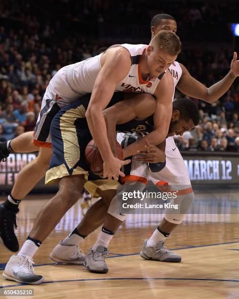 Jack Salt of the Virginia Cavaliers fights for a rebound against Sheldon Jeter of the Pittsburgh Panthers during the second round of the ACC...