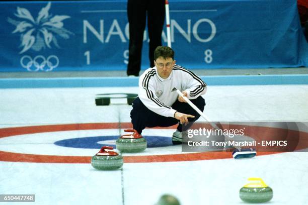 Douglas Dryburgh of Great Britain watches his granite stone curl towards the house