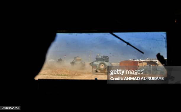 Iraqi forces' armoured vehicles and humvees advance in the Shuhada neighbourhood of west Mosul during the advance against Islamic State group...