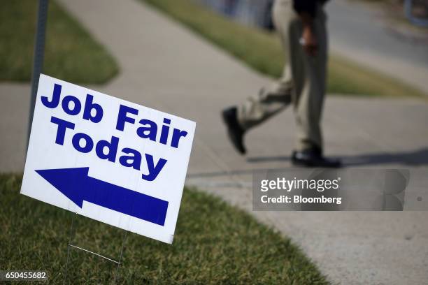 Signage is displayed outside a Job News USA career fair in Overland Park, Kansas, U.S., on Wednesday, March 8, 2017. Applications for U.S. Jobless...