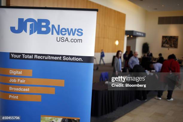 Signage is displayed in the lobby outside a Job News USA career fair in Overland Park, Kansas, U.S., on Wednesday, March 8, 2017. Applications for...