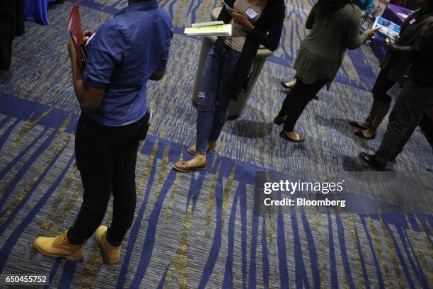 Job seekers wait to speak with recruiters during a Job News USA career fair in Overland Park, Kansas, U.S., on Wednesday, March 8, 2017. Applications...