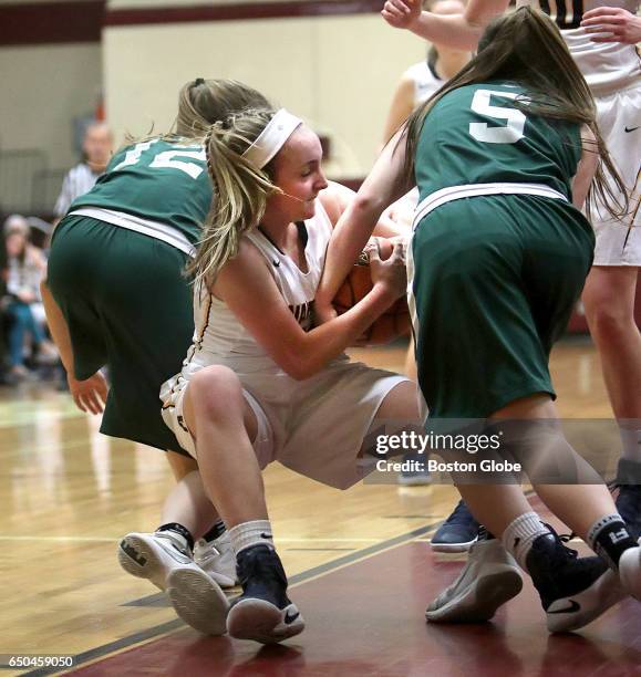 Andover High School's Alexa Pacy battles Billerica's Madison Bonvie and Nicole Wedge during a Div. I girls semi-final basketball game played at...