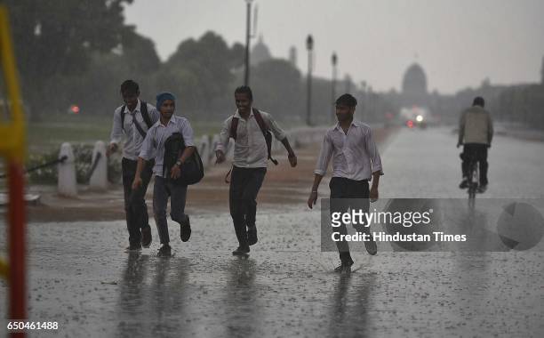 Students enjoy sudden heavy rain, on March 9, 2017 in New Delhi, India. The national capital could witness scattered rain and thundershowers,...