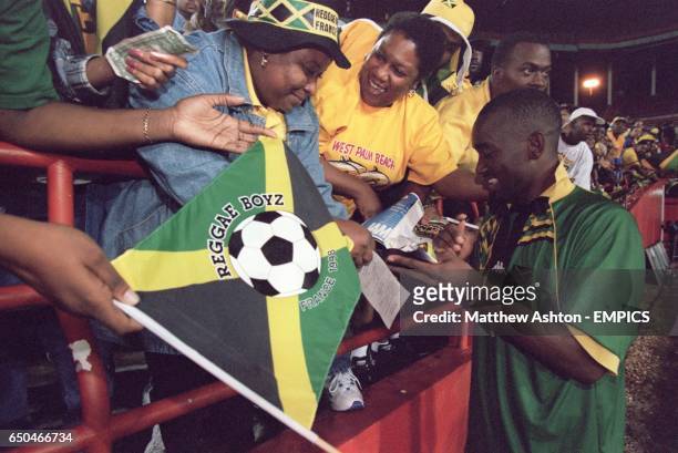 Jamaica's Linval Dixon gives fans his autograph
