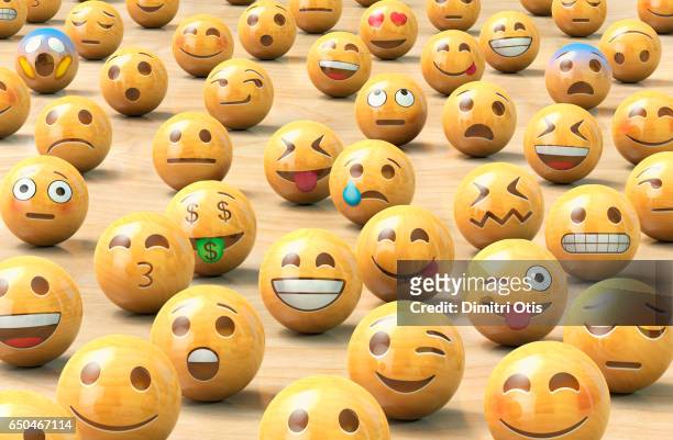a crowd of wooden emoticon or emoji face balls - antropomorfisme stockfoto's en -beelden