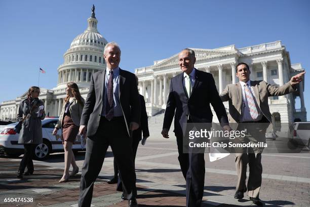 Sen. Chris Van Hollen and Senate Minority Leader Charles Schumer head for a news conference with people who may be negatively affected by the...