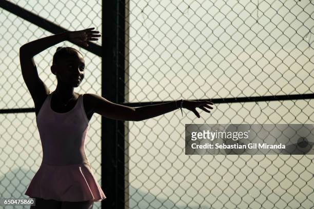 Ester, Tuany's sister, 12 years old, during a class. Ballet students in the project "Na Ponta dos Pés" , organized by a former professional...