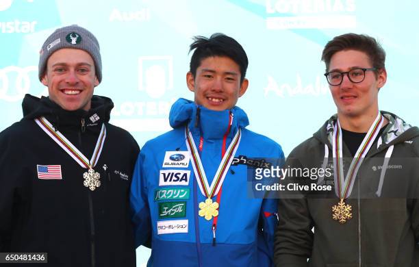 Ikuma Horishima of Japan celebrates winning the gold medal with silver medallist Bradley Wilson of the United States and bronze medallist Marco Tade...