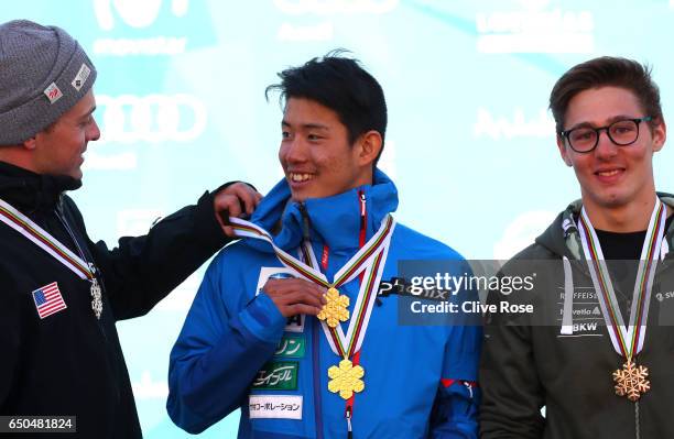 Ikuma Horishima of Japan wears his two gold medals with silver medallist Bradley Wilson of the United States and bronze medallist Marco Tade of...